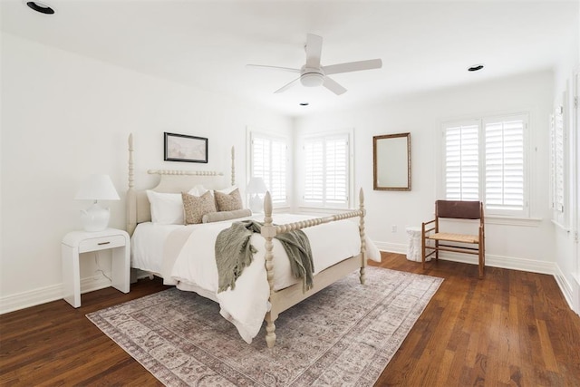 bedroom featuring multiple windows, dark wood-type flooring, and ceiling fan