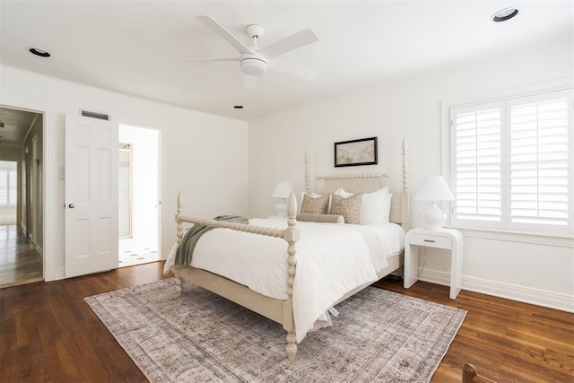 bedroom with ceiling fan and dark hardwood / wood-style flooring