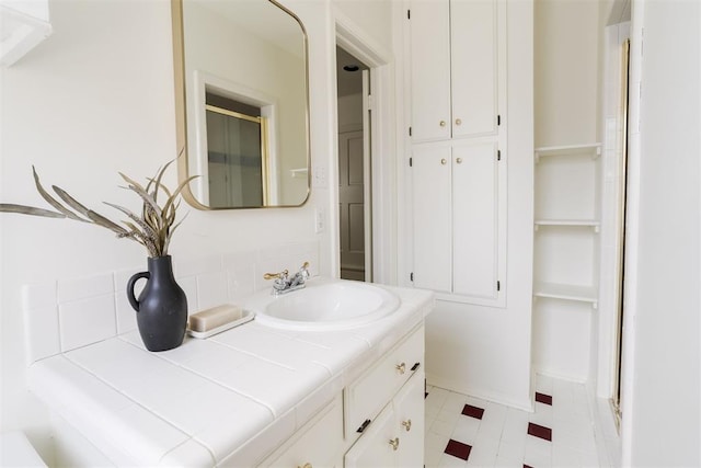 bathroom featuring vanity and backsplash