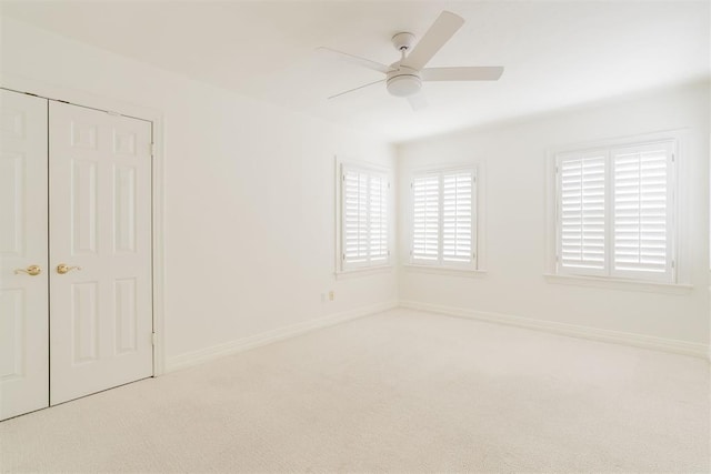 unfurnished bedroom with ceiling fan, a closet, and carpet