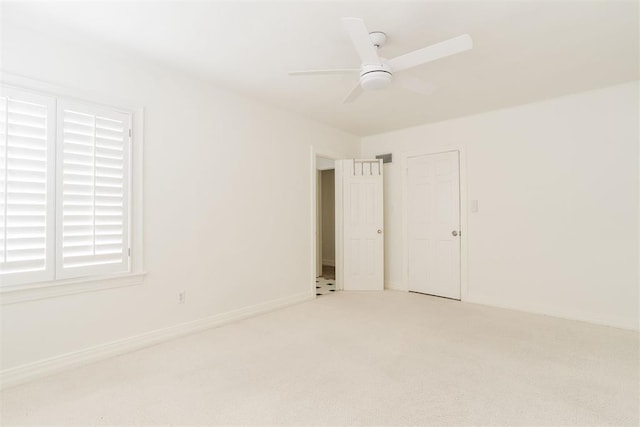 carpeted empty room featuring ceiling fan