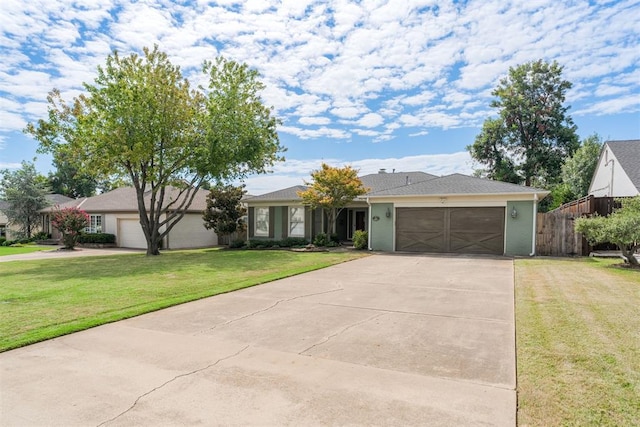 ranch-style house featuring a garage and a front yard