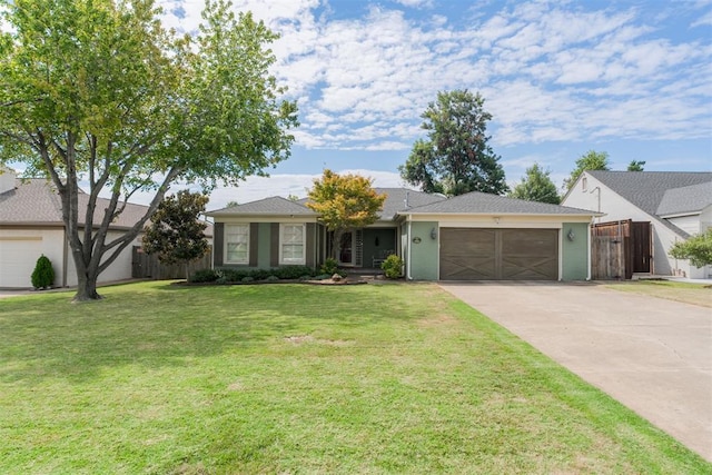 single story home featuring a garage and a front yard