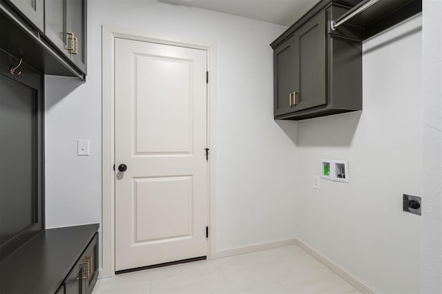 clothes washing area featuring cabinet space, baseboards, washer hookup, and hookup for an electric dryer