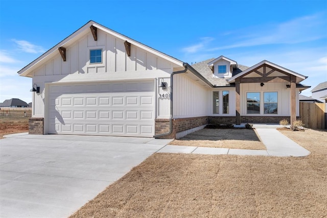 view of front of house with board and batten siding, brick siding, driveway, and an attached garage