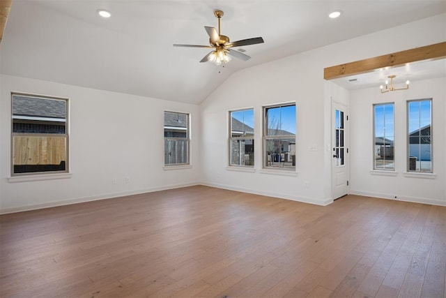 interior space featuring recessed lighting, vaulted ceiling, wood finished floors, baseboards, and ceiling fan with notable chandelier