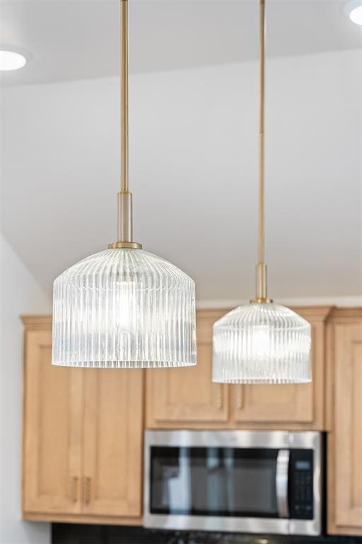 room details with stainless steel microwave and light brown cabinetry