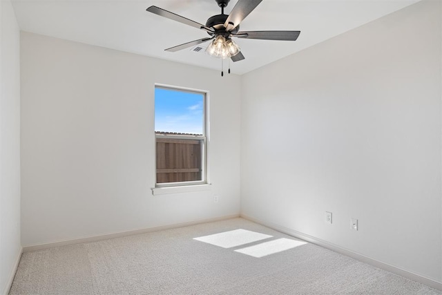 unfurnished room featuring ceiling fan, carpet, and baseboards