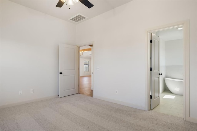 unfurnished bedroom with a ceiling fan, baseboards, visible vents, and carpet flooring