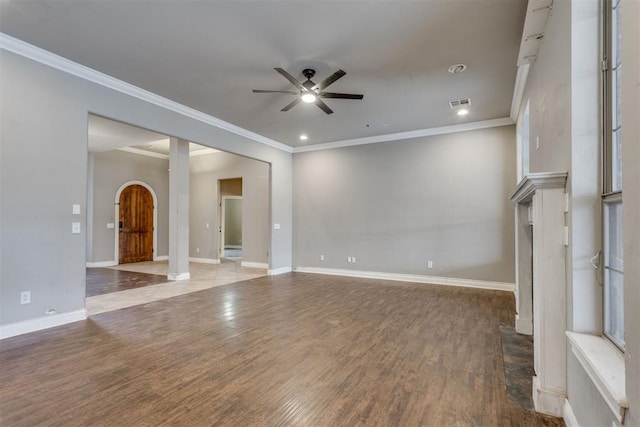 unfurnished living room with ceiling fan, ornamental molding, and light wood-type flooring