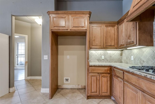 kitchen featuring light tile patterned floors, custom range hood, and backsplash