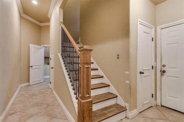 stairs featuring tile patterned flooring and ornamental molding