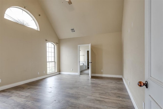 spare room featuring ceiling fan, high vaulted ceiling, and light hardwood / wood-style flooring