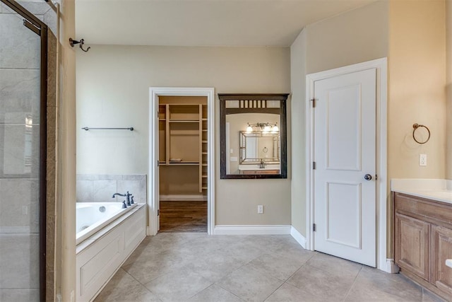 bathroom featuring vanity, shower with separate bathtub, and tile patterned flooring