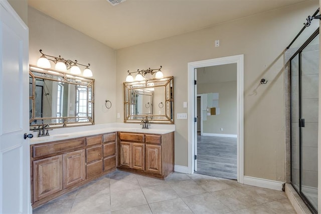 bathroom with vanity, an enclosed shower, and tile patterned floors