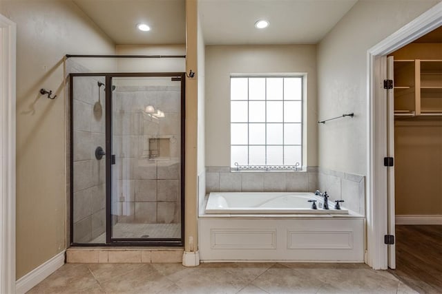 bathroom featuring tile patterned flooring and independent shower and bath