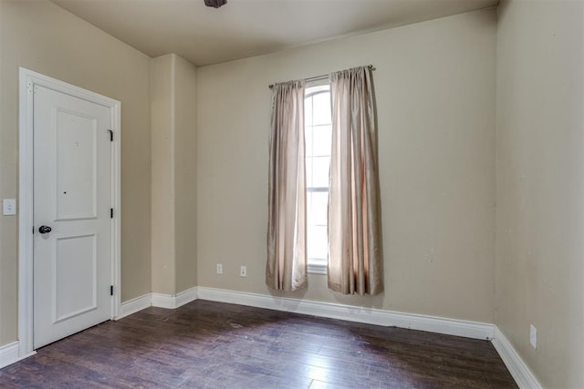 empty room with dark wood-type flooring