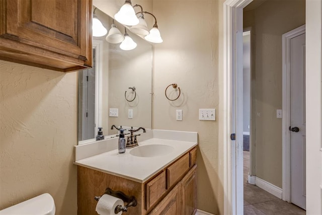 bathroom with tile patterned floors, vanity, and toilet