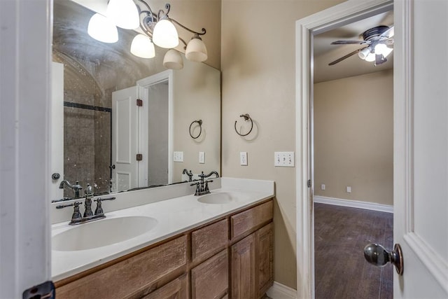 bathroom with hardwood / wood-style flooring, vanity, and ceiling fan with notable chandelier