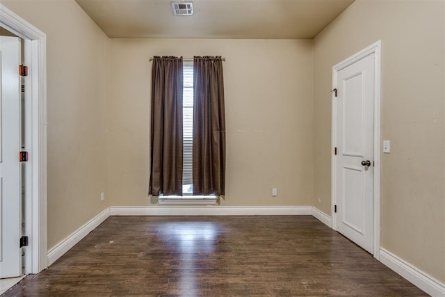 empty room featuring dark hardwood / wood-style flooring