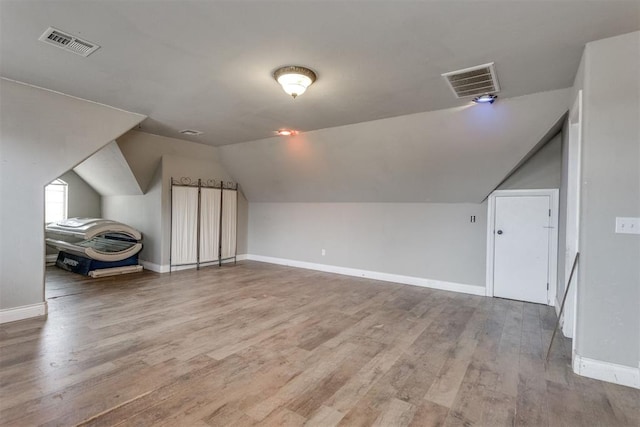 bonus room featuring hardwood / wood-style flooring and lofted ceiling