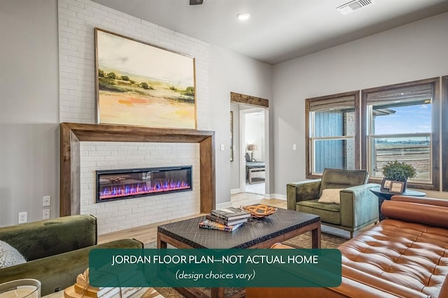 living room with hardwood / wood-style flooring and a fireplace