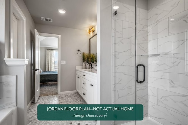 bathroom featuring a shower with door and vanity