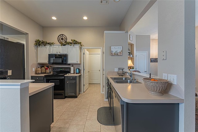 kitchen featuring white cabinets, kitchen peninsula, sink, and black appliances