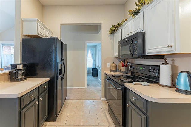 kitchen featuring gray cabinets, white cabinetry, light tile patterned floors, and black appliances