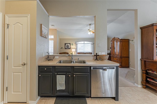 kitchen featuring lofted ceiling, sink, light tile patterned floors, dishwasher, and ceiling fan