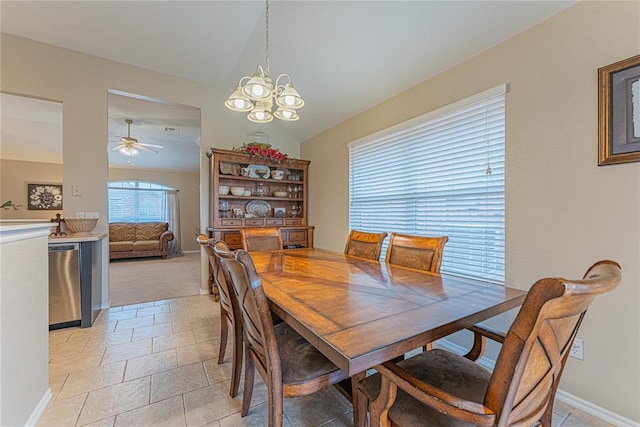 dining area featuring vaulted ceiling and ceiling fan with notable chandelier