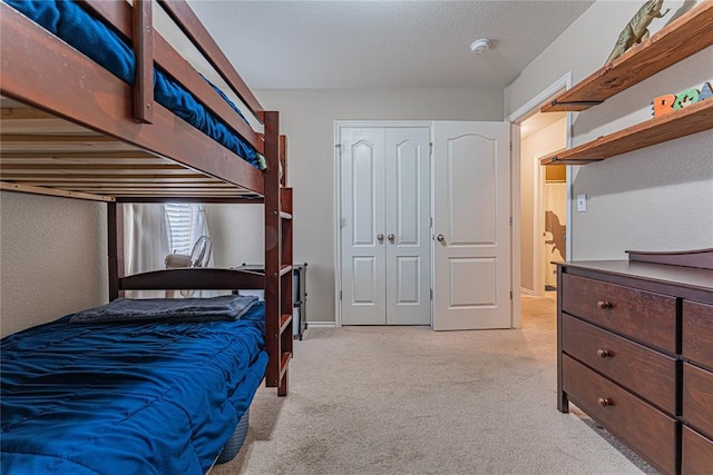 carpeted bedroom with a closet