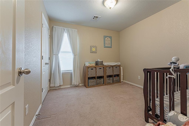 carpeted bedroom featuring a textured ceiling