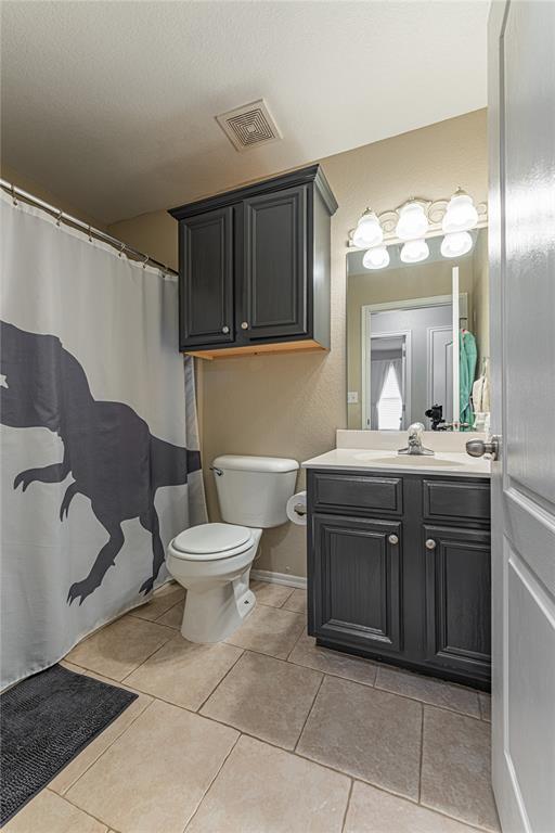 bathroom with tile patterned floors, toilet, and vanity