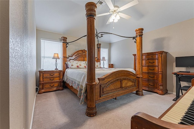 carpeted bedroom featuring multiple windows and ceiling fan