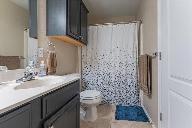 bathroom with a shower with curtain, vanity, tile patterned floors, and toilet