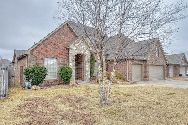 front of property with a garage and a front lawn