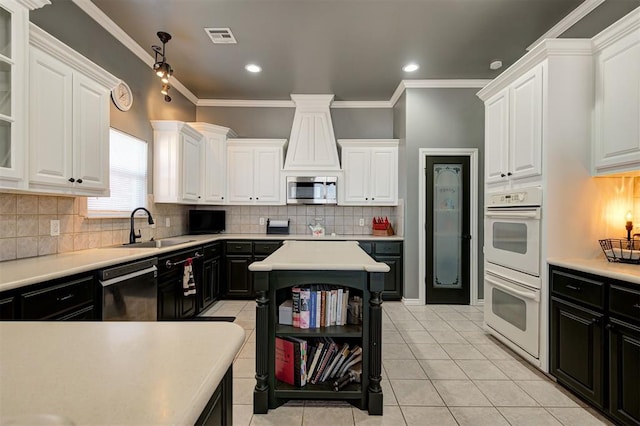 kitchen featuring white double oven, sink, dishwasher, and white cabinets