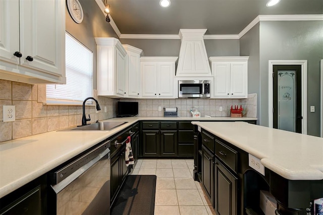 kitchen with sink, crown molding, light tile patterned floors, stainless steel appliances, and white cabinets