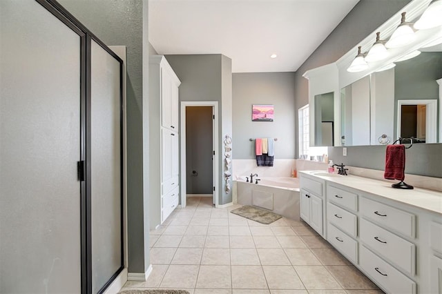 bathroom featuring tile patterned flooring, vanity, and separate shower and tub