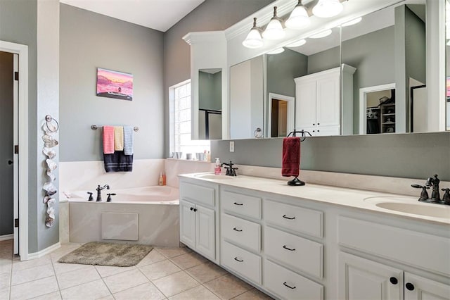 bathroom with vanity, tile patterned flooring, and a washtub