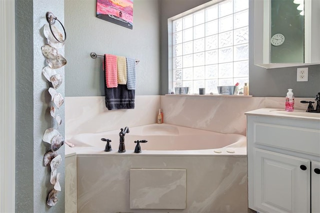 bathroom featuring vanity and a washtub