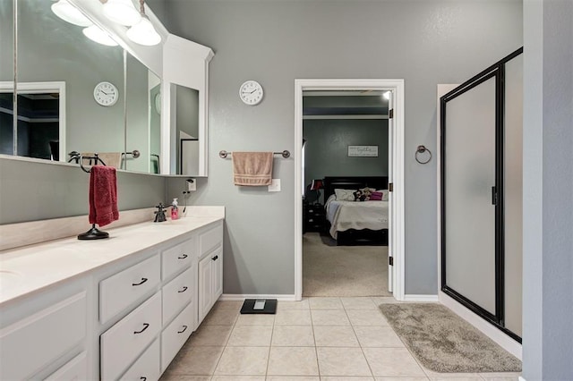 bathroom with tile patterned flooring, vanity, and walk in shower