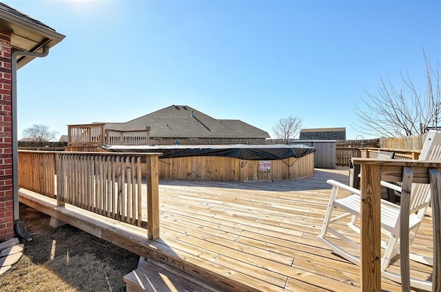 wooden terrace featuring a hot tub