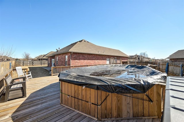 wooden terrace with a hot tub