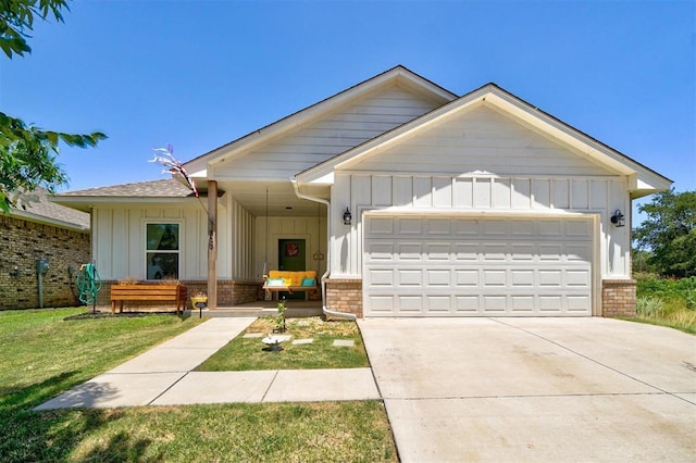 view of front of property featuring a garage and a front lawn