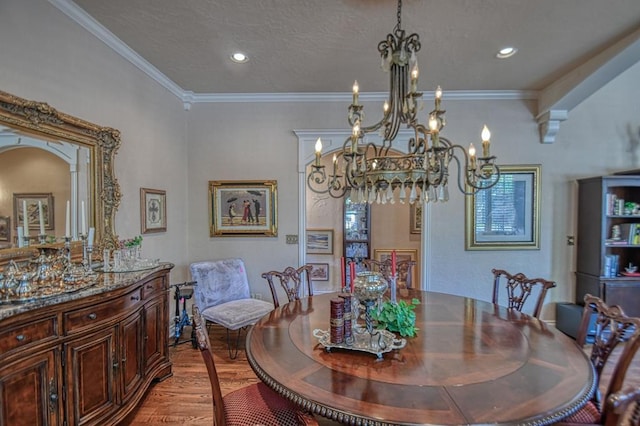 3225 Cotswold Sq, Norman, OK 73072 - dining space featuring hardwood / wood-style flooring, ornamental molding, a notable chandelier, and a textured ceiling