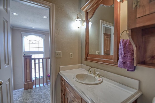 3225 Cotswold Sq, Norman, OK 73072 - bathroom featuring vanity, crown molding, and a textured ceiling