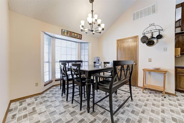 dining space featuring brick floor, visible vents, a notable chandelier, and baseboards