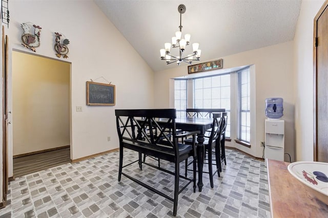 dining room with brick floor, vaulted ceiling, baseboards, and an inviting chandelier